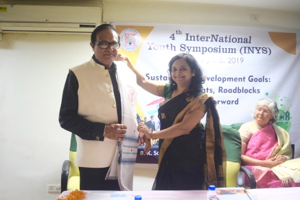Prof. Pawan K. Chugan, Guest of Honor of Valedictory Function of 4th International Youth Symposium, B. K. School of Business Management, Gujarat University, Ahmedabad, is being honoured with Shawl by Prof. Nilam Panchal, the chairperson of the Symposium.